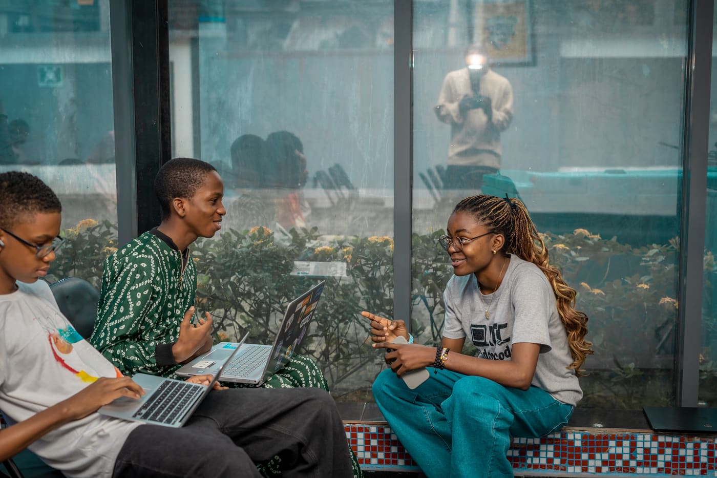 Students discussing a project by the window