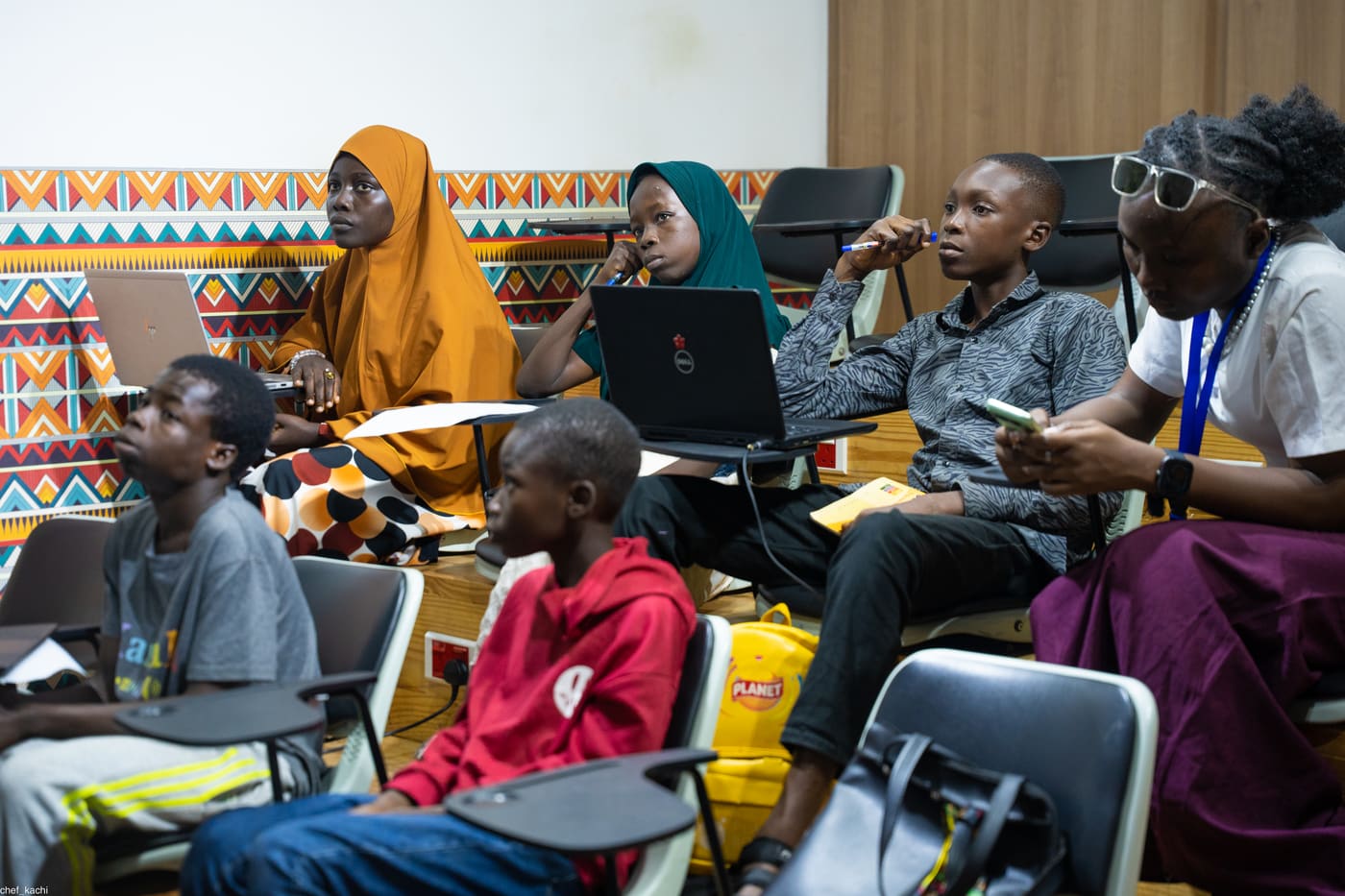 A full classroom of students at laptops