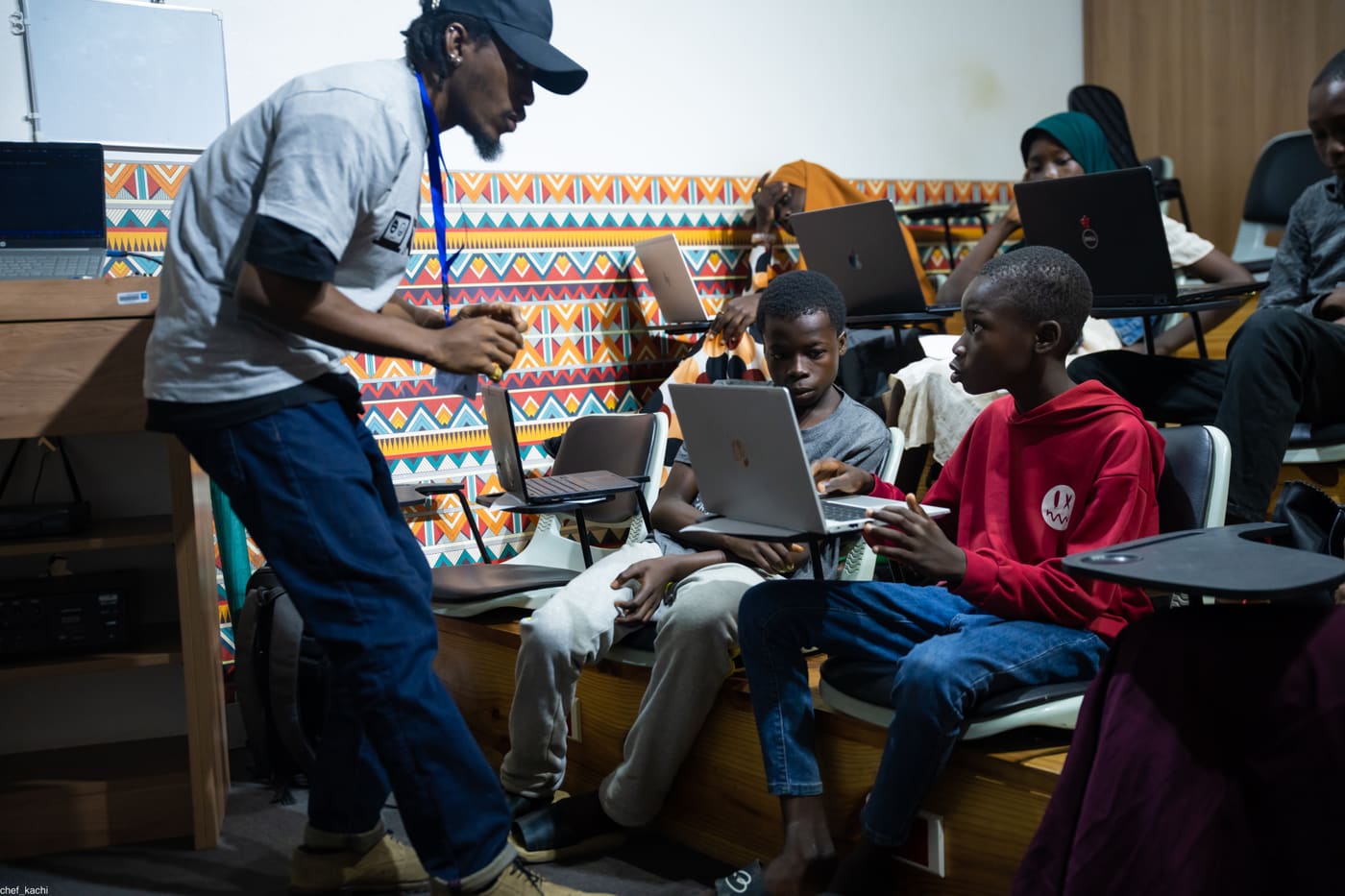 A tutor checking in with students during class
