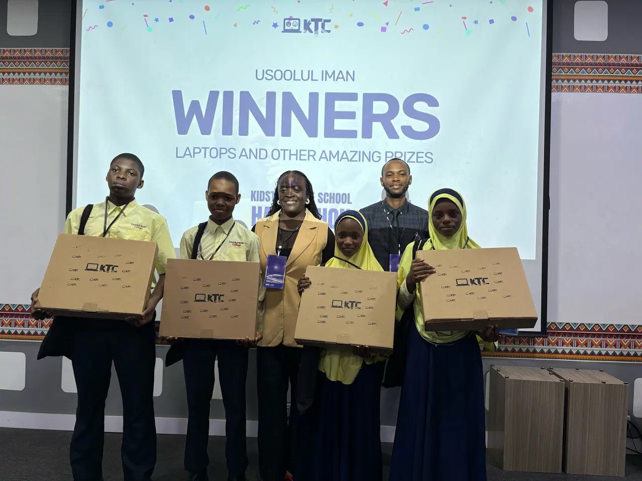 Usoolul Iman College winners holding their KTC laptops