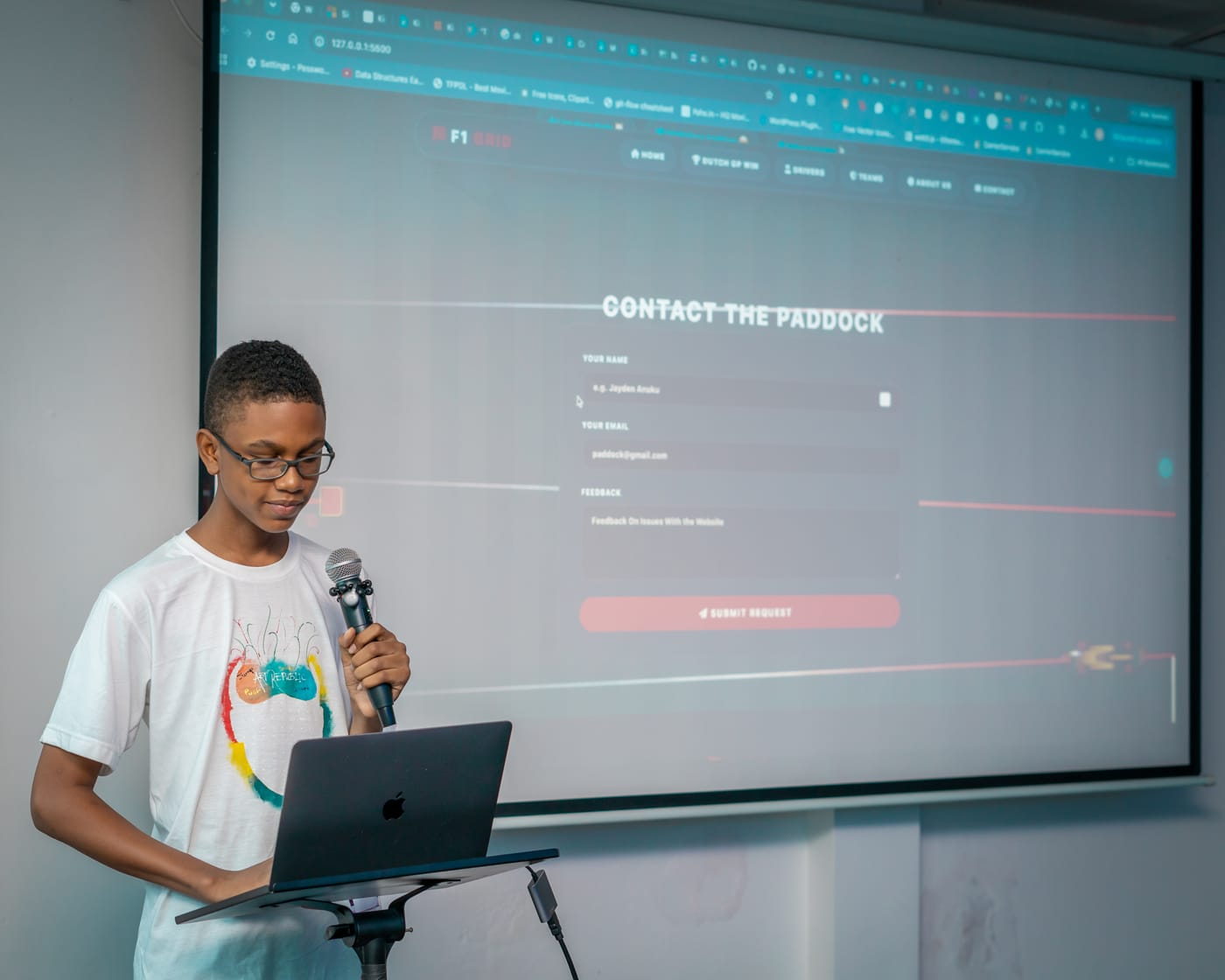 A student presenting the website he built at a KTC demo day